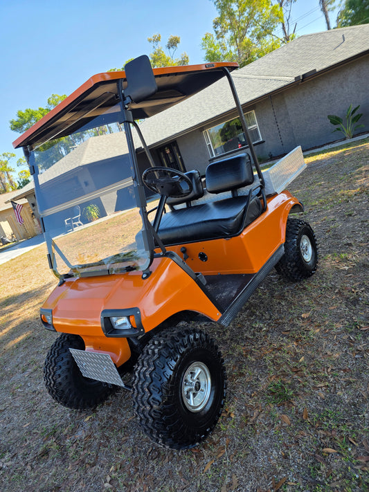 1995 Club Car DS Lifted – 36V | Orange | 23” All-Terrain Tires