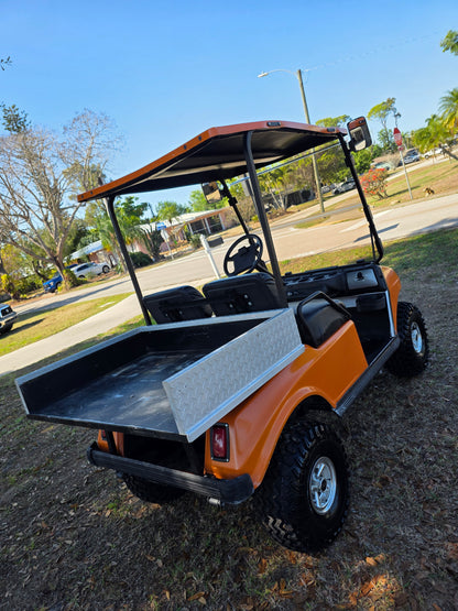 1995 Club Car DS Lifted – 36V | Orange | 23” All-Terrain Tires