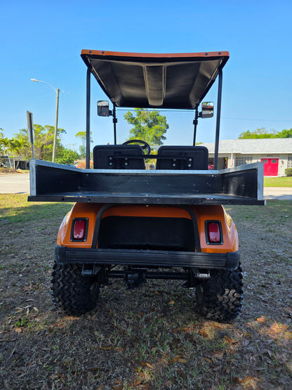1995 Club Car DS Lifted – 36V | Orange | 23” All-Terrain Tires