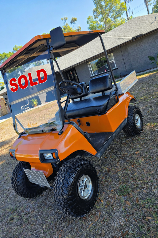 1995 Club Car DS Lifted – 36V | Orange | 23” All-Terrain Tires